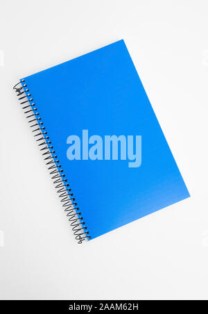 Blue notebook binder isolated on a light background.  Office supply object for business related concepts, or writing.  Use as a mockup. Stock Photo