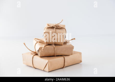 Stack of handcraft gift boxes on white background Stock Photo