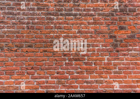 generic background of stone textured and colored orange red and dirty flushed ancient brick factory wall Stock Photo