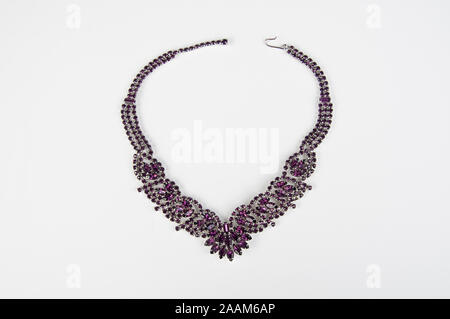 Purple amethyst women's necklace isolated on light background.  Beautiful fashion accessory for ladies of jewelry gemstones. Stock Photo
