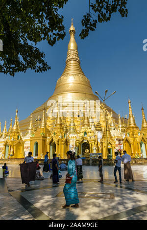 worshippers gathering for prayers at the Shwedagon pagoda site. This Buddhist temple is the most important one in the country. Stock Photo