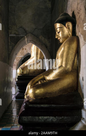 Sitting Buddha statue in one of the atmospheric corridors of Gawdawpalin temple in Old Bagan, the part of Bagan Temple complex, the UNESCO World Herit Stock Photo