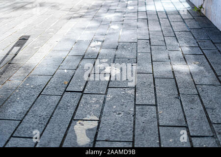 Wet footprints on concrete tiles. Stock Photo