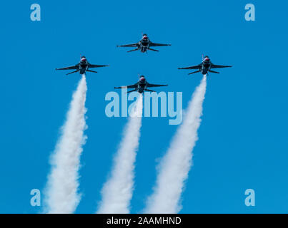 Wantaugh, New York, USA - 24 May 2019: The United States Air Force Thunderbirds flying in a tight formation with white smoke coming out of the back of Stock Photo