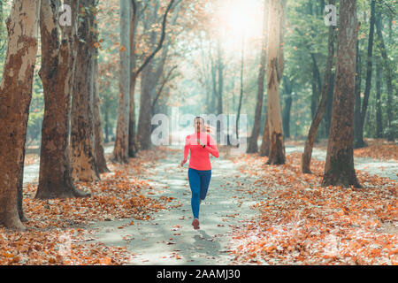 Woman jogging in a park Stock Photo
