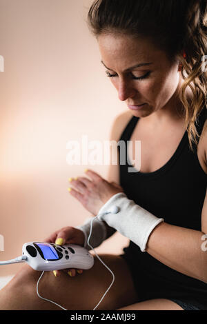 Physical therapy with TENS machine Stock Photo