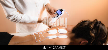 TENS (transcutaneous electrical nerve stimulation) knee physical therapy  Stock Photo - Alamy