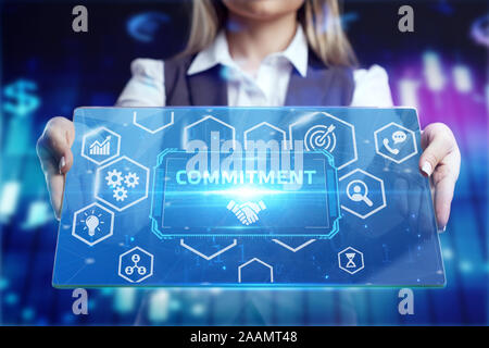 Business, Technology, Internet and network concept. Businessman working on the tablet of the future, select on the virtual display: commitment Stock Photo