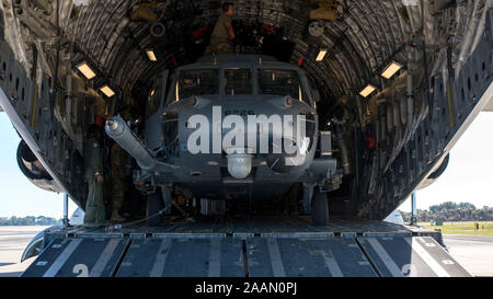 An HH-60 Pave Hawk helicopter assigned to the 305th Rescue Squadron (RQS), Davis-Monthan Air Force Base, Ariz., sits inside a C-17 Globemaster III assigned to the 436th Airlift Wing, Dover Air Force Base, Dela., at MacDill Air Force Base, Fla., Nov. 20, 2019. MacDill hosted the 305th RQS as they participated in a Joint Force deployment exercise with U.S. Army Special Forces members. (U.S. Air Force photo by Airman 1st Class Ryan C. Grossklag) Stock Photo