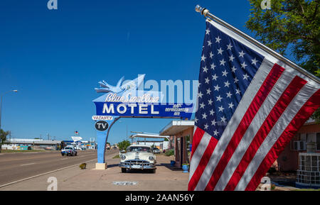 Tucumcari, New Mexico, USA. May 14, 2019. American flag covers a part of Motel Blue Swallow building, that located next to route 66. An antique pontia Stock Photo