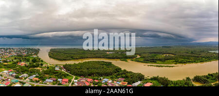 Arcus clouds over Papar, Sabah. An arcus cloud is a low, horizontal cloud formation, usually appearing as an accessory cloud to a cumulonimbus. Stock Photo