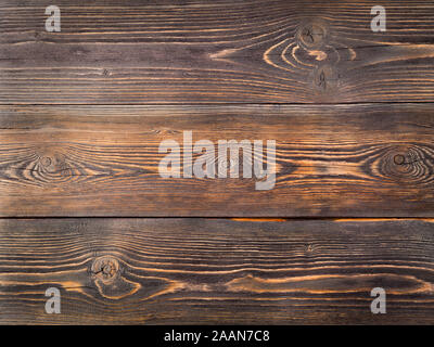 painted in brown, wood background from pine boards, contrasting the structure of the tree with knots Stock Photo