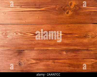 painted in brown, wood background from pine boards, contrasting the structure of the tree with knots Stock Photo