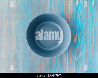 empty ceramic bowl for soup on the old wood turquoise table Stock Photo