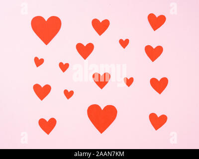 symbol of Valentine's day -  pink background with lots of red hearts, top view Stock Photo