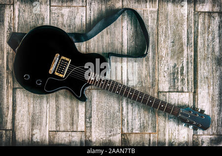 electric guitar grunge look studio shot up view on wooden background Stock Photo