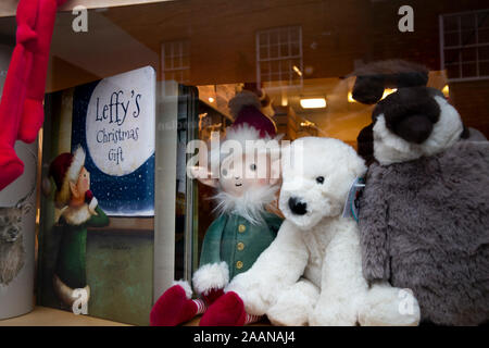 festive Christmas shop window display of soft cuddly toys on sell for presents Stock Photo