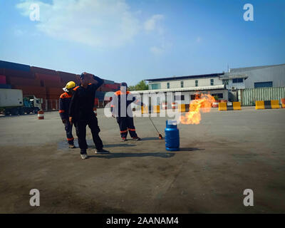 Firefighters come to teach and practice fire fighting for company employees. Stock Photo