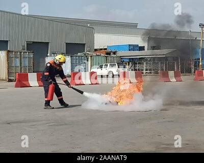 Firefighters come to teach and practice fire fighting for company employees. Stock Photo