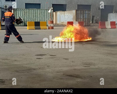 Firefighters come to teach and practice fire fighting for company employees. Stock Photo