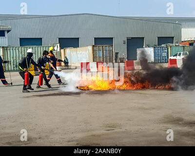 Firefighters come to teach and practice fire fighting for company employees. Stock Photo