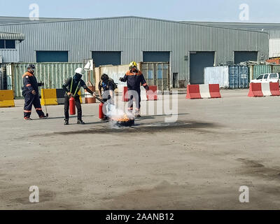 Firefighters come to teach and practice fire fighting for company employees. Stock Photo