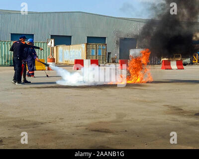 Firefighters come to teach and practice fire fighting for company employees. Stock Photo