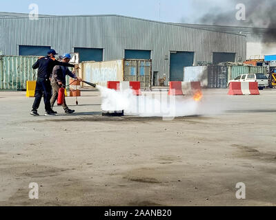 Firefighters come to teach and practice fire fighting for company employees. Stock Photo