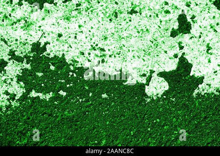 Old asphalt surface with white paint close-up, top view. Abstract background. Green color toned Stock Photo