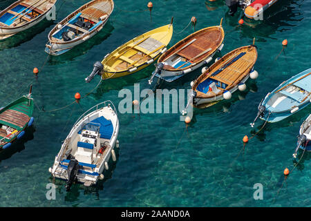 Small old wood fishing boats floating on the water. They are