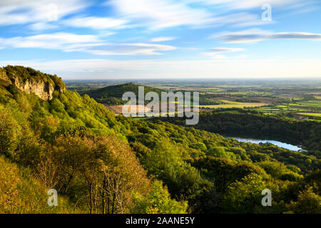 Beautiful scenic long-distance view (Lake Gormire, Hood Hill, Whitestone Cliff, countryside & blue sky) - Sutton Bank, North Yorkshire, England, UK. Stock Photo