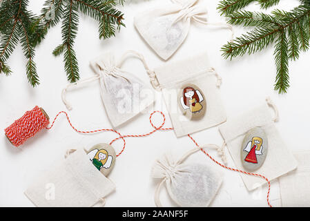 Stones decorated with Angels motifs as a Christmas gift. Top view. Stock Photo