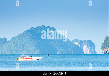 Speed Boat in the sea  background Island and clouds on the sky  at Krabi in Thailand. Stock Photo