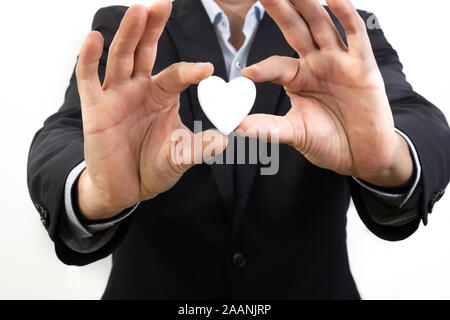 Business man showing a heart - peoples business Stock Photo