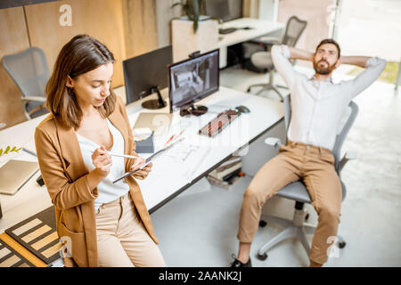 Collegues having some creative work using digital tablet and pencil at the modern office studio. Concept of digital designing on a tablet Stock Photo