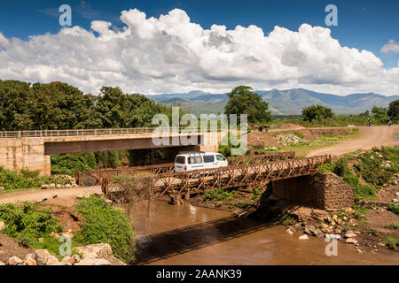 Ethiopia, Karat-Konso, minibus driving across old bridge crossing river Stock Photo