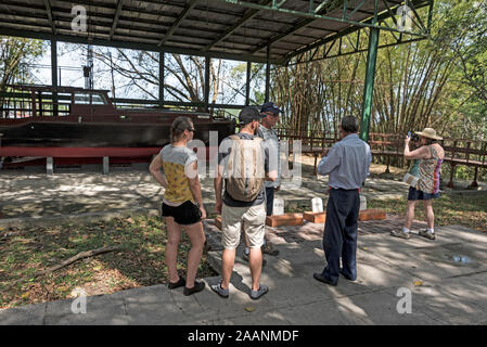 Visitors admiring American writer Ernest Hemingway’s 38-foot-long fishing boat, ‘Pilar’.   It is kept under cover at his home in Finca La Vigia, San F Stock Photo