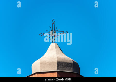 Wrought iron cross on a clear blue sky on the top of a bell tower, Christian religious symbol. Church of San Giorgio, Tellaro, Liguria, Italy Stock Photo