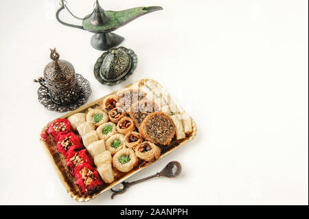 Eid Mubarak with Arabic sweets. Dried dates and tea in Arabic glasses ...