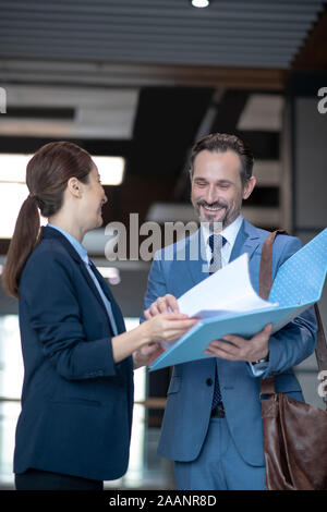 Couple of businessmen smiling while feeling happy after signing contract Stock Photo