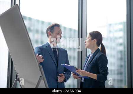 Business lady talking to her investor while presenting her business plan Stock Photo