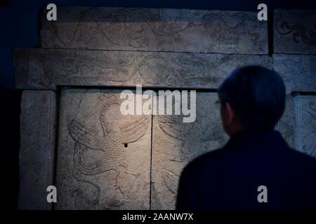 Nanyang, China's Henan Province. 22nd Nov, 2019. A visitor looks at an exhibit at the Nanyang Stone-Carved Art Museum in Nanyang, central China's Henan Province, Nov. 22, 2019. Founded in 1935, the Museum of Han Dynasty Stone Carvings features more than 2,000 stone carving exhibits unearthed in mausoleums built between the late third century BC and the early third century AD. Credit: Feng Dapeng/Xinhua/Alamy Live News Stock Photo