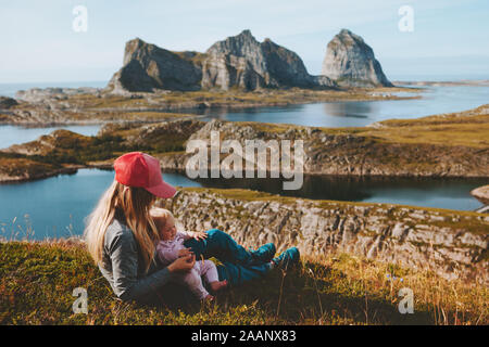 Mother with baby traveling together enjoying mountains and sea view family healthy lifestyle mom and child active vacations outdoors Mothers day holid Stock Photo