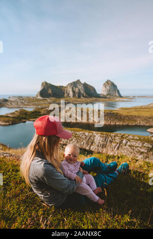 Mother and child relaxing outdoor traveling together enjoying mountains islands view family lifestyle mom and baby active vacations Mothers day Stock Photo
