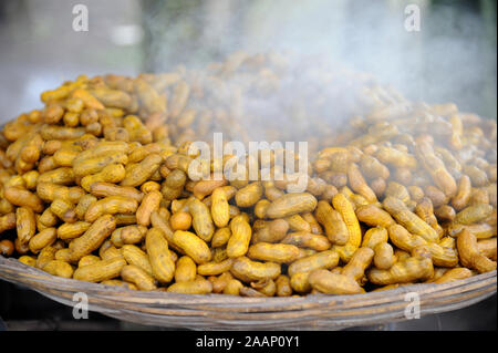 Pune; Maharashtra India; Sept. 2015: Southeast Asia - Hot groundnut Arachis hypogea in basket for sale at sinhagad fort Stock Photo