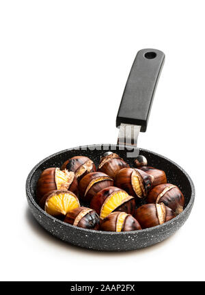 Roasted chestnuts in grilling pan over dark scorched wooden background  stock photo (153974) - YouWorkForThem