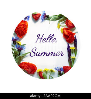 Spring floral composition from poppies, cornflowers, irises, and wild flowers with green leaves, hello spring writing  inside of flowering frame, flat Stock Photo