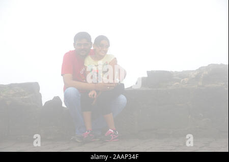 Pune; Maharashtra; India; Sept. 2015: Southeast Asia - Indian Father and daughter Enjoying Foggy morning at sinhagad fort Pune Stock Photo