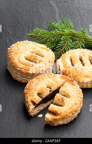 Christmas  butter mince pies on black stone background. Top view. Stock Photo