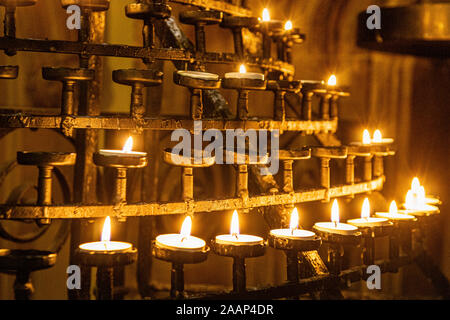 Prayer or Votive Candles Burning on a Stand In St Giles' Cathedral Edinburgh, Scotland. Stock Photo